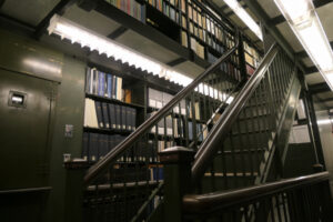 Stairway to the stacks and Connecticut Documents on the shelves.